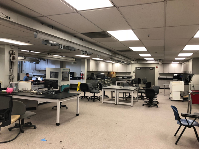Interior of Automated Manufacturing Lab with one student working in the distance