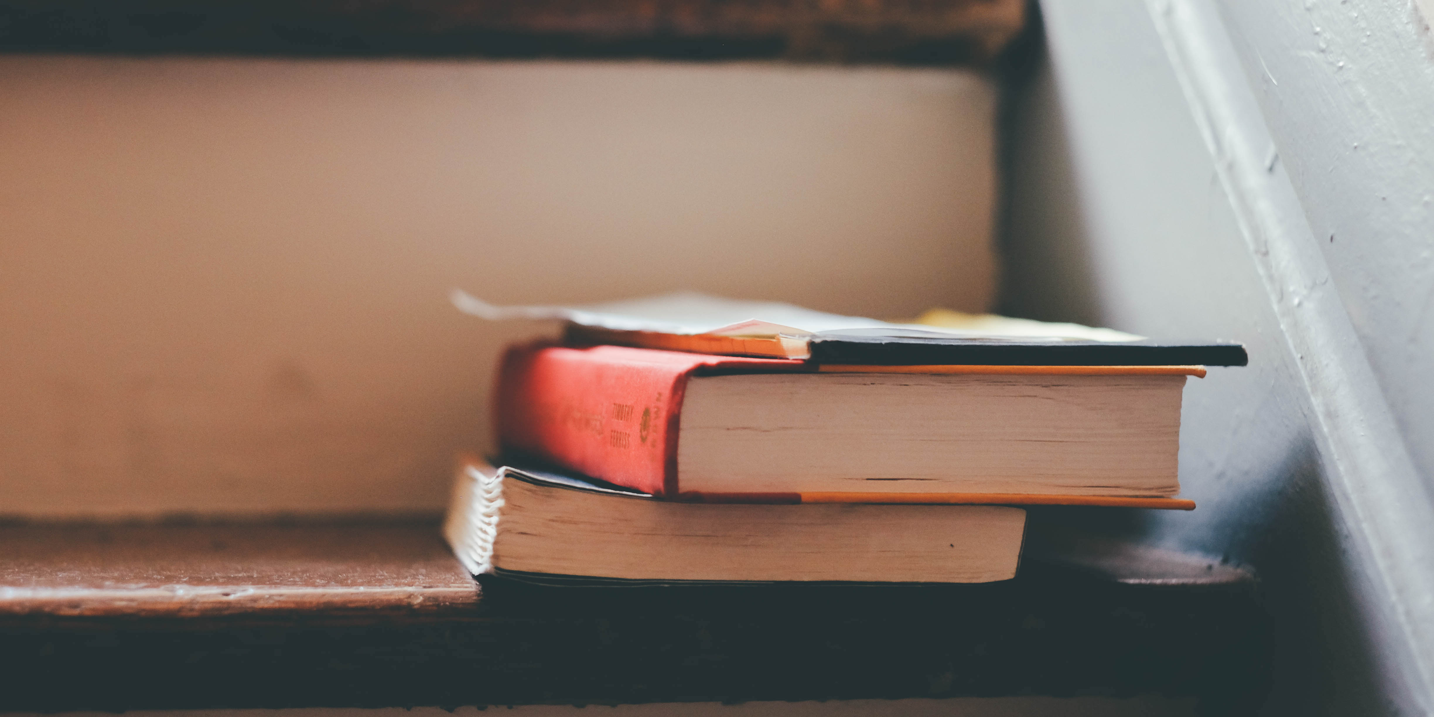 Two books stacked on a step