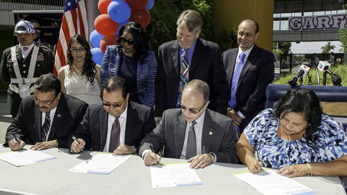 From left: Garfield High School Principal Jose Huerta, East Los Angeles College President Marvin Martinez, President Covino and LAUSD Board Member Monica Garcia sign their commitment to the GO East L.A. project.