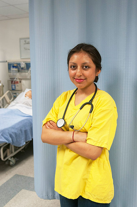 Maria Daniela Nina, picture in the Nursing Simulation lab, has one more year until her bachelor's degree in nursing.