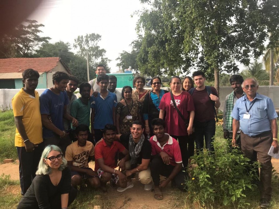 Students pose with a group in India.