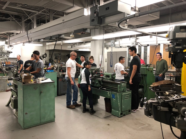 Students working with machines in the Kenneth R. Thomas Machine Tool Lab