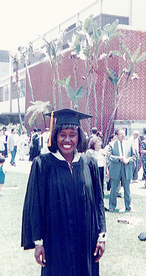 Moyofune Shabazz smiling in graduation gown.