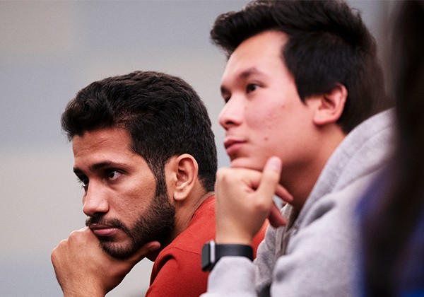 two students listening pensively