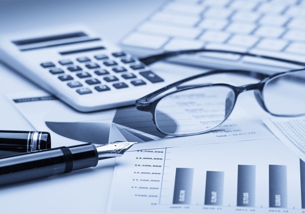 calculator and glasses on financial paperwork