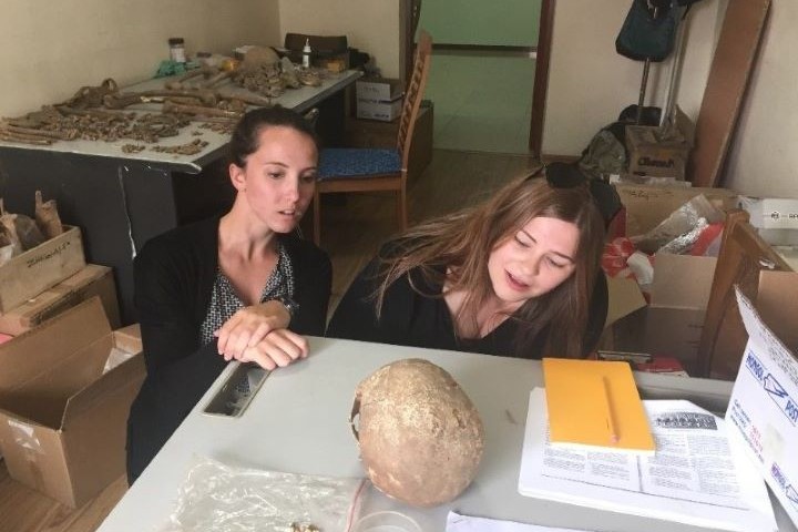 Amaretta and Jennifer examine a skull