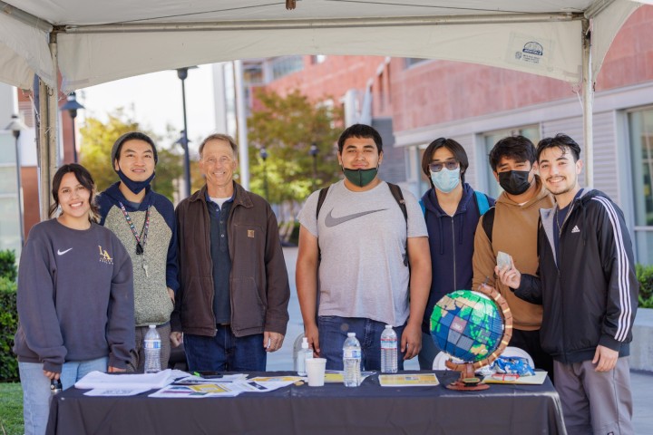 Group of Geosciences and Environment staff and students standing outside of La Kretz Hall at Cal State LA