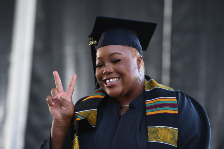 Cal State LA Student at Graduation showing Peace Sign