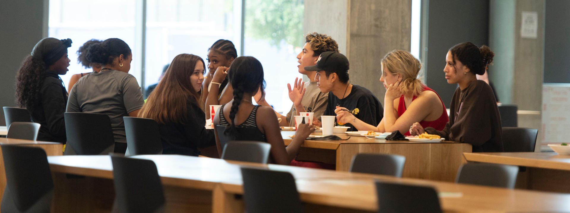 A group of students eating and talking.