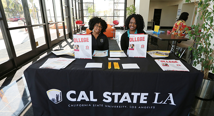 Cal State LA recruitment outreach staff at a table for Super Sunday