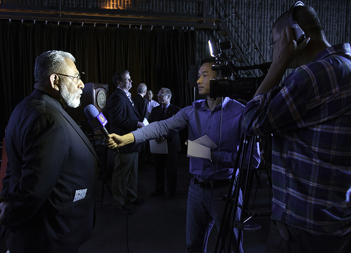 Television, Film, and Media Studies Department Chair John Ramirez is interviewed by a film crew at the grand opening.