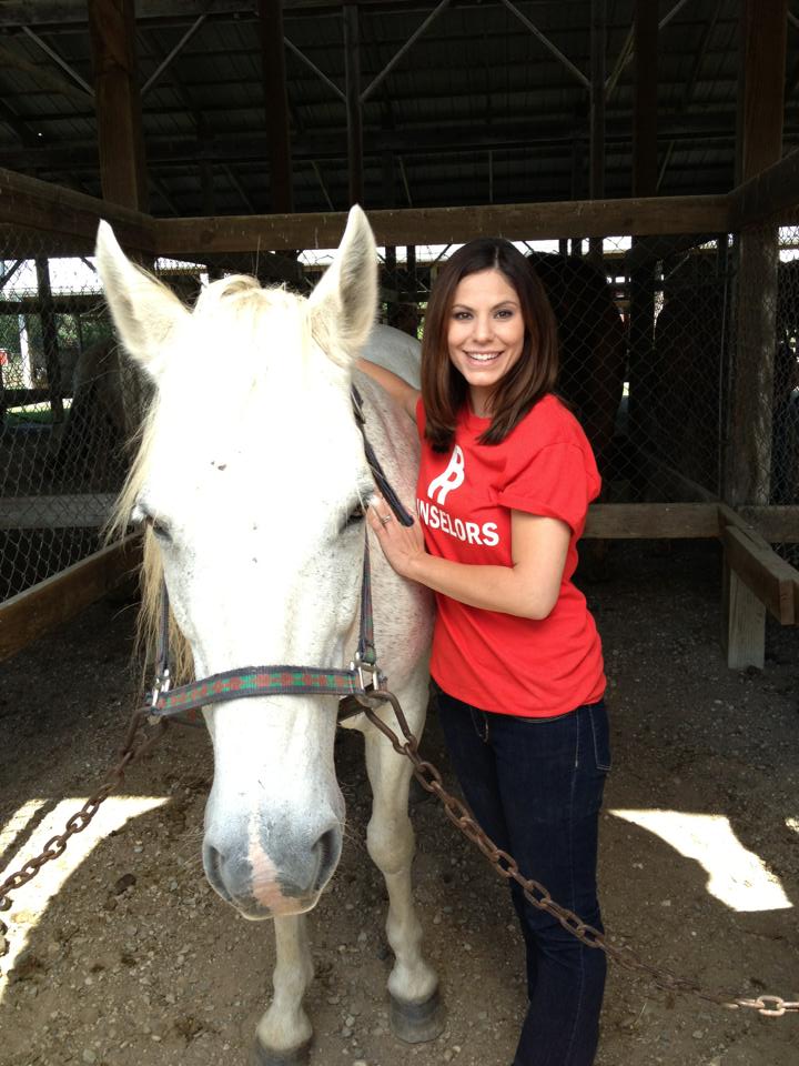 Miss Jessica (Kristin Mellian) gets Aspen ready for riding lessons.