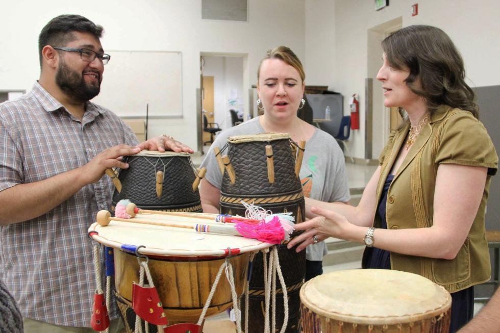 Dr. Moss with students and the world instrument collection