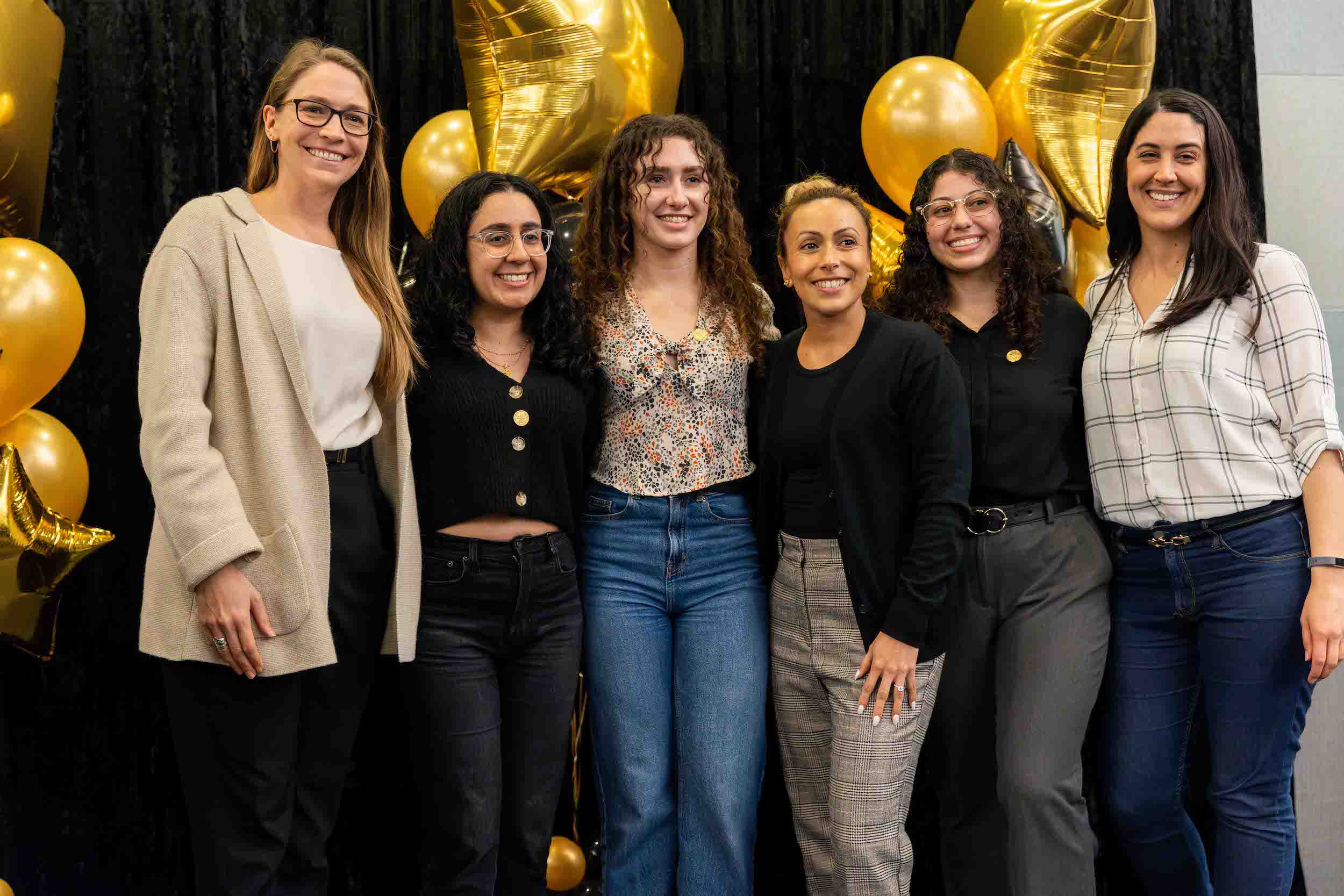 Group of students pose with their professors