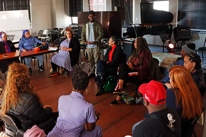 Lecture Seminar at Witwatersrand University, School of the Arts, in Johannesburg, South Africa with speaker standing and everyone else in a circle