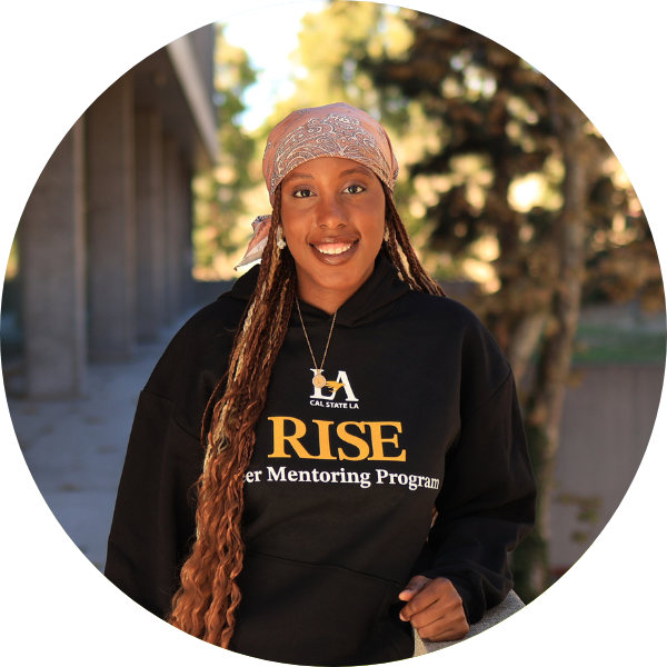 A black woman with braids and black hoodie smiling at the camera.