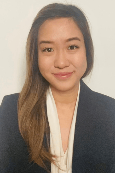 A person with long hair smiling