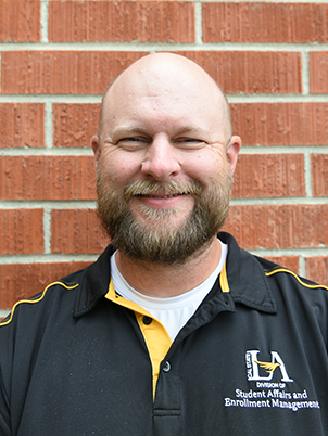 person with a beard smiling