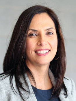 A person with long hair smiling