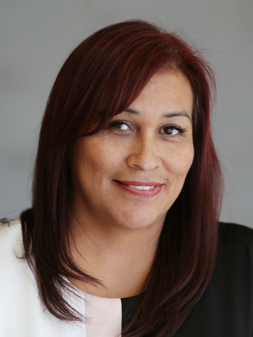 A person with should-length hair smiling.