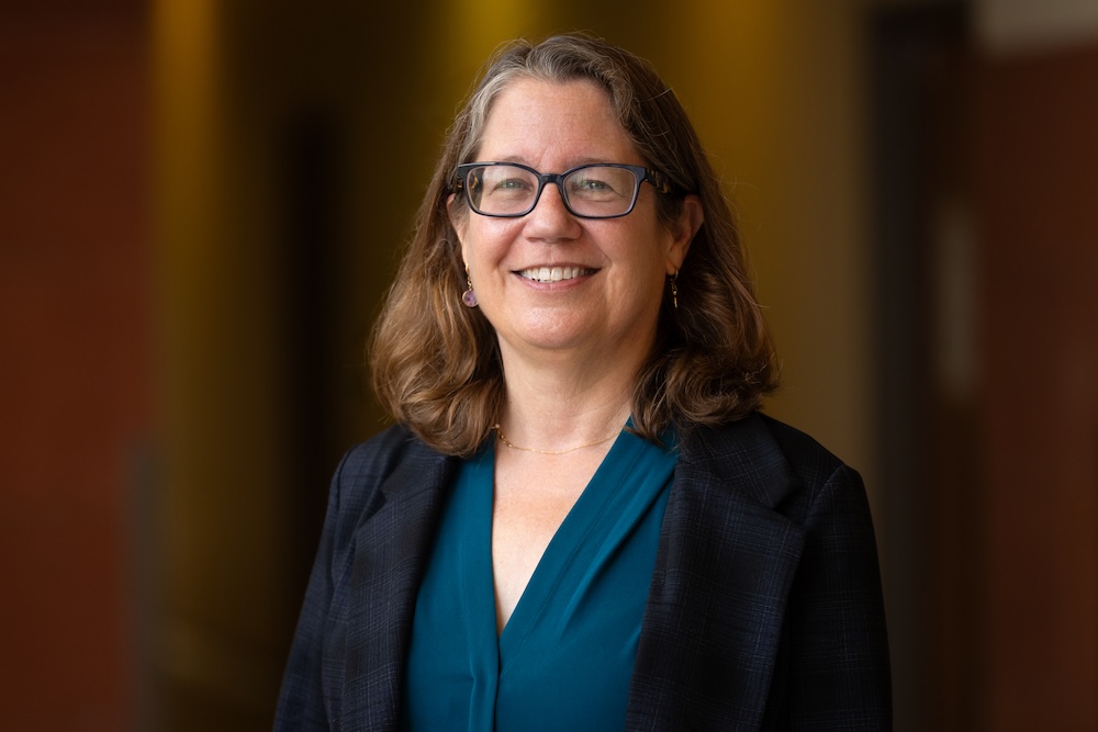 Dr. Alison McCurdy wearing a black blazer with a blue top