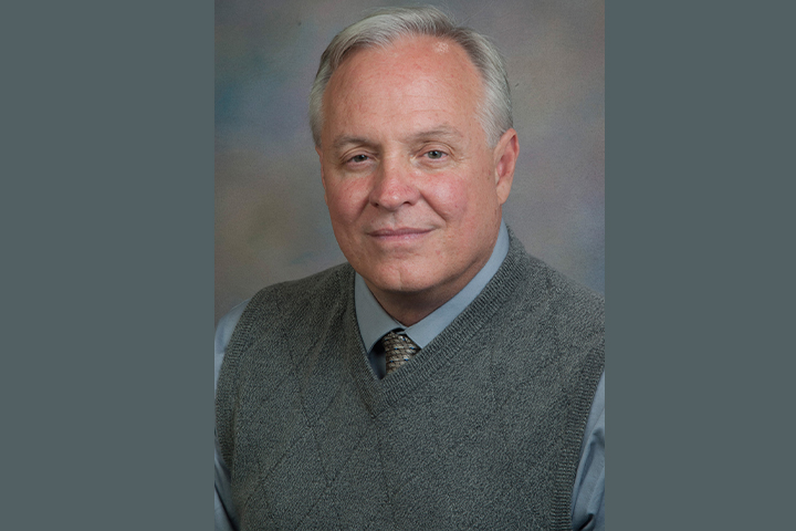 Dr. Hibbs wearing a sweater vest with a tie