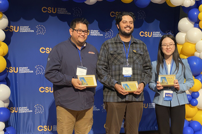 ECST student with plaques at CSU 40th student research competition