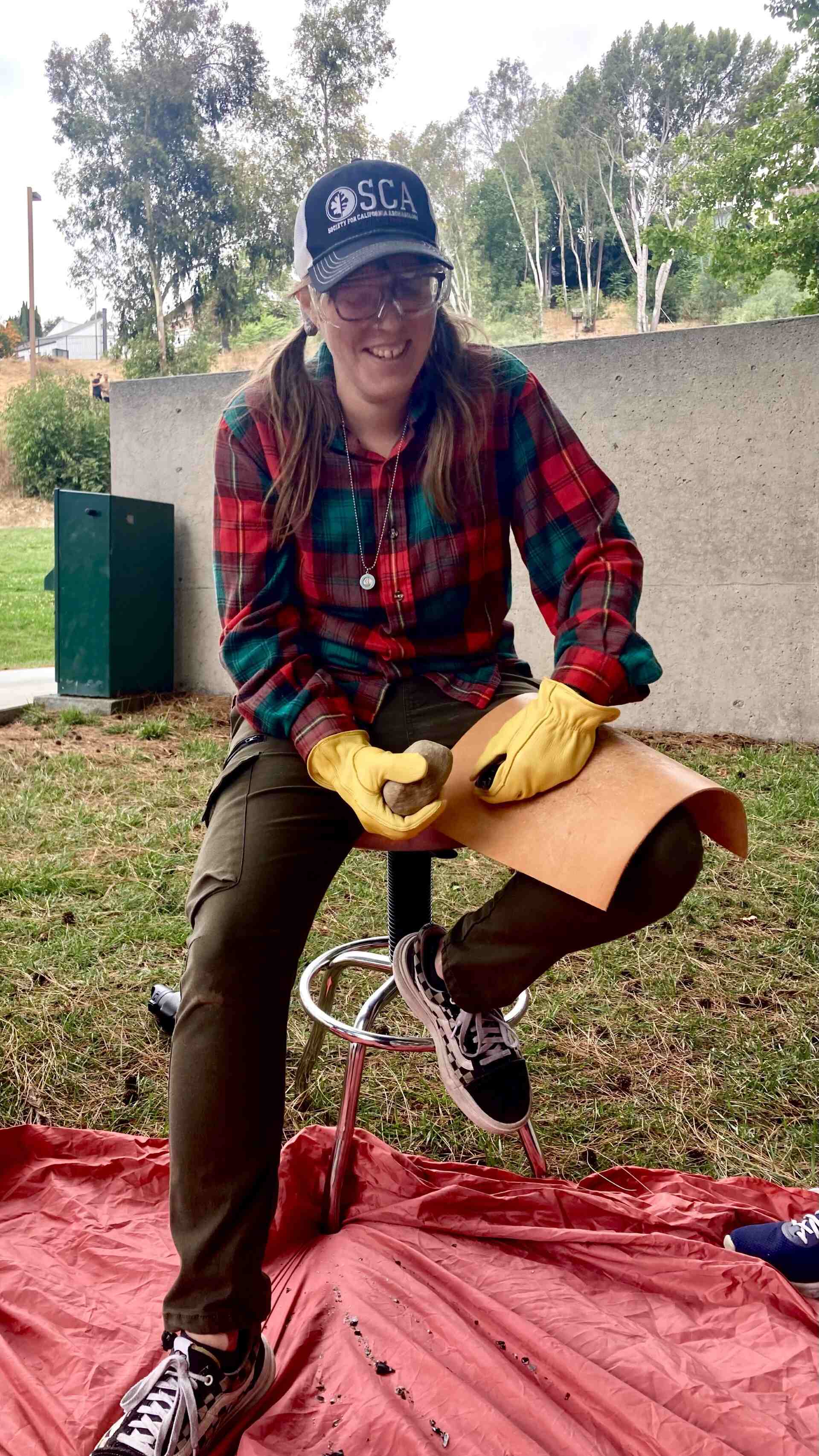 Photo of Graduate Student Heidi Buratti flintknapping during a campus workshop.