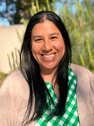 Person with long hair smiling.