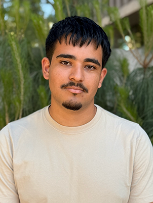 A person with short hair and facial hair 