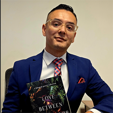 A person in a suit and tie holding up a book.