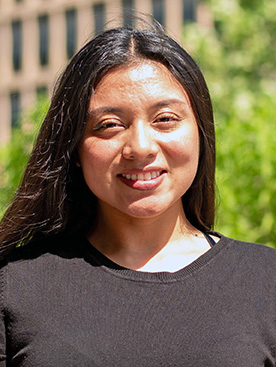 A person with long hair smiling