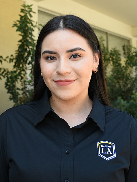 A person wearing a Cal State LA polo shirt.