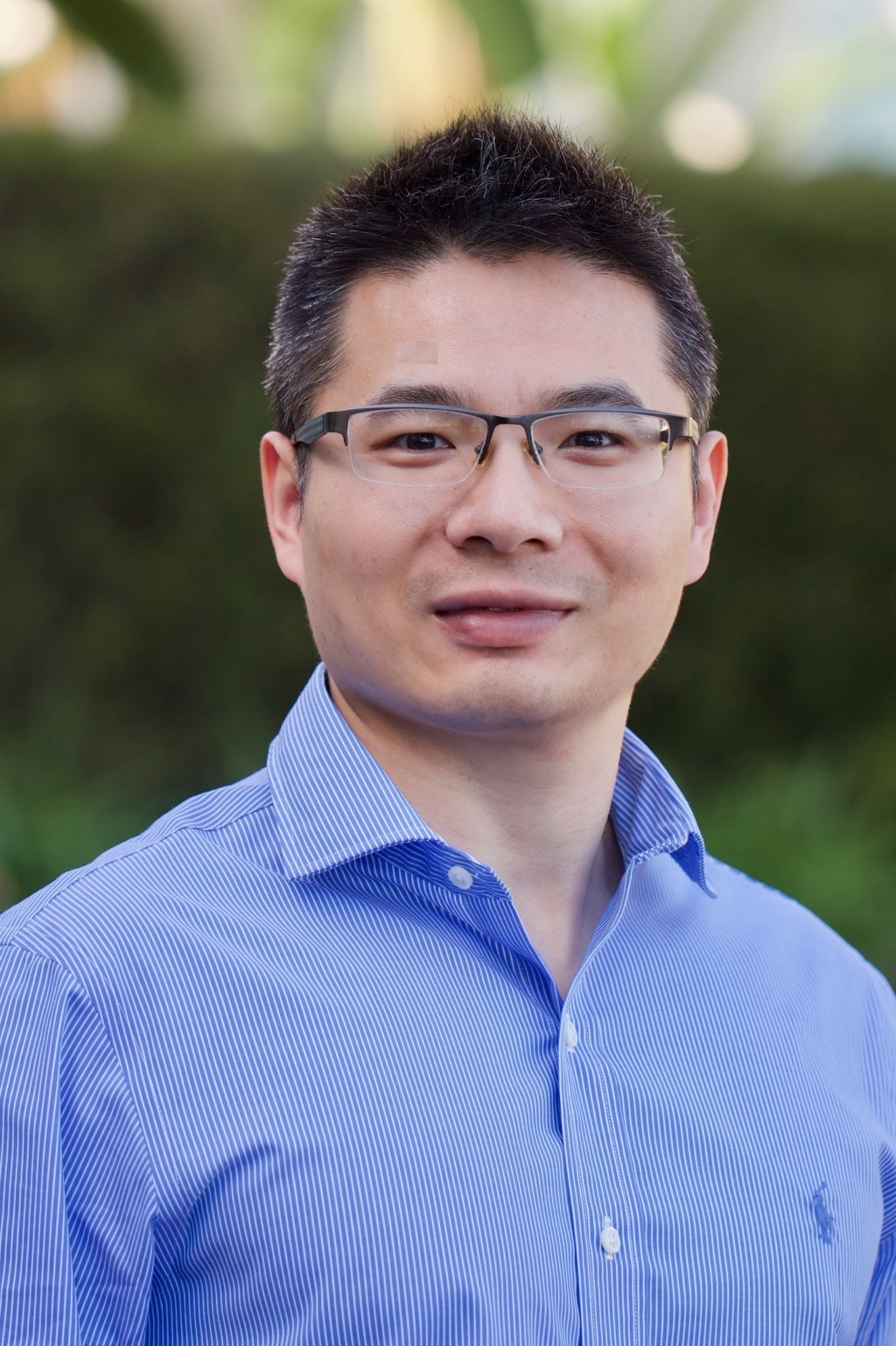 Jie Zhong wearing a blue shirt