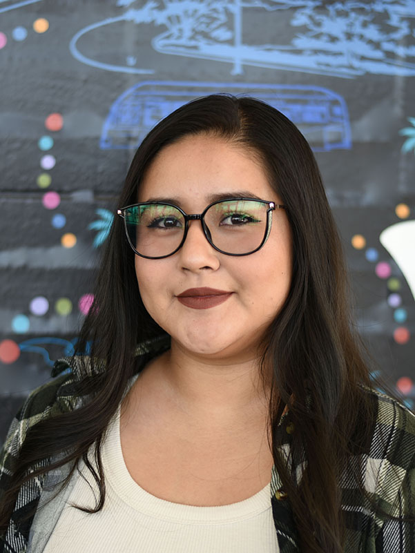 A person with long hair and glasses.