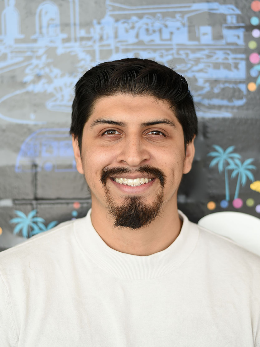 A person with short hair and goatee smiling.