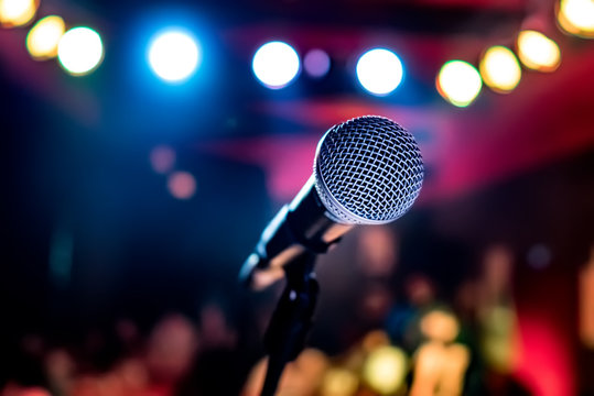 A microphone shining underneath bright lights
