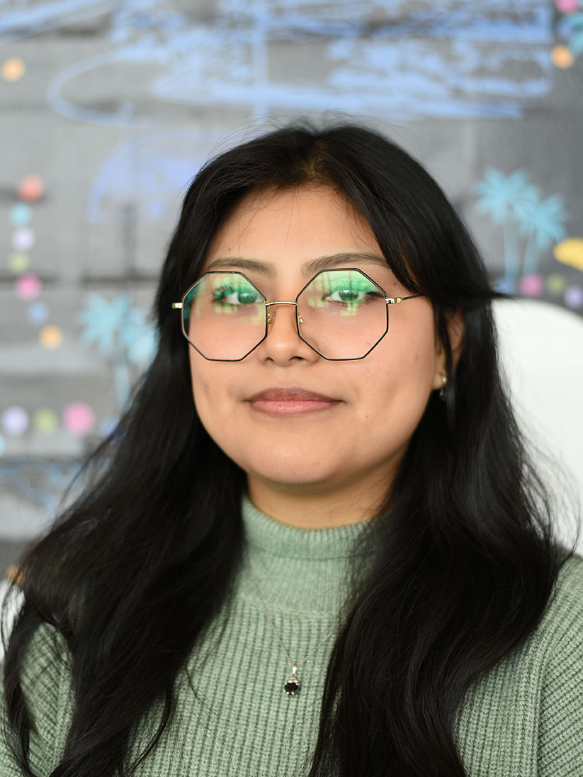 A person with long hair and glasses.