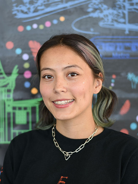 A person with short hair smiling.