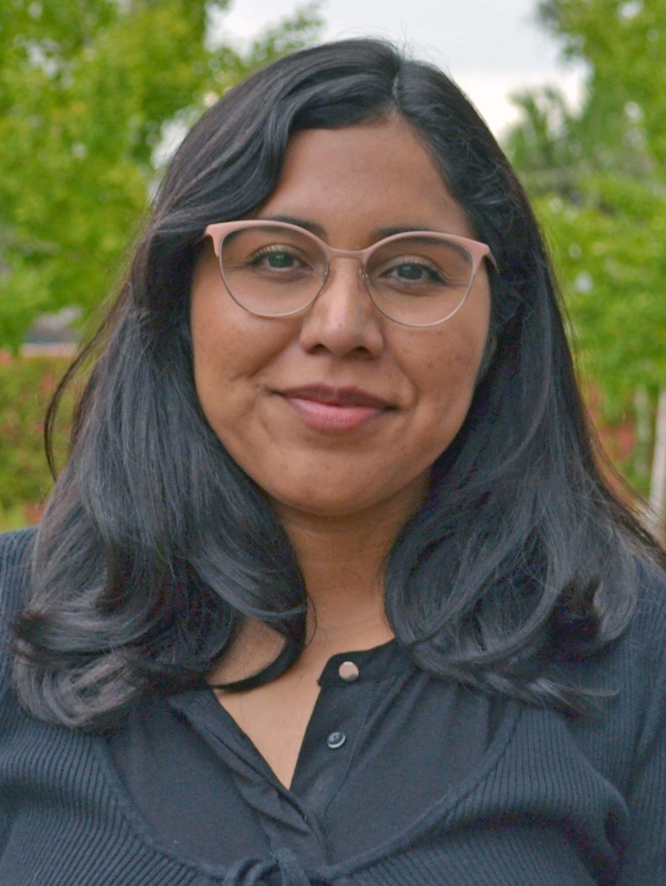 A person with long hair and glasses.