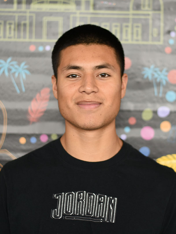 A person with short hair and a slight smile.