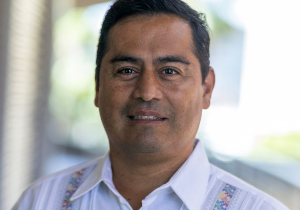 a person in a white shirt with colorful embroidery