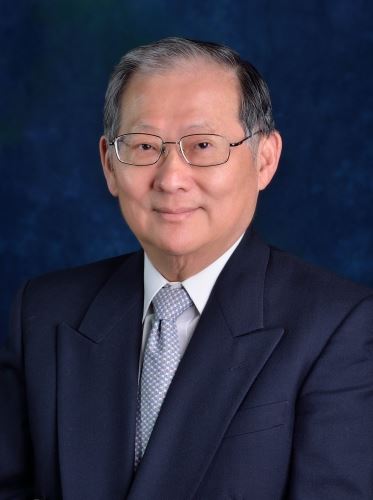 Ming Lu Huang wearing a dark suit