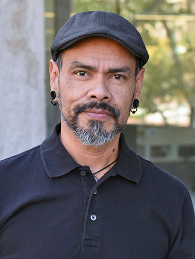 A person with a bearing wearing a hat.