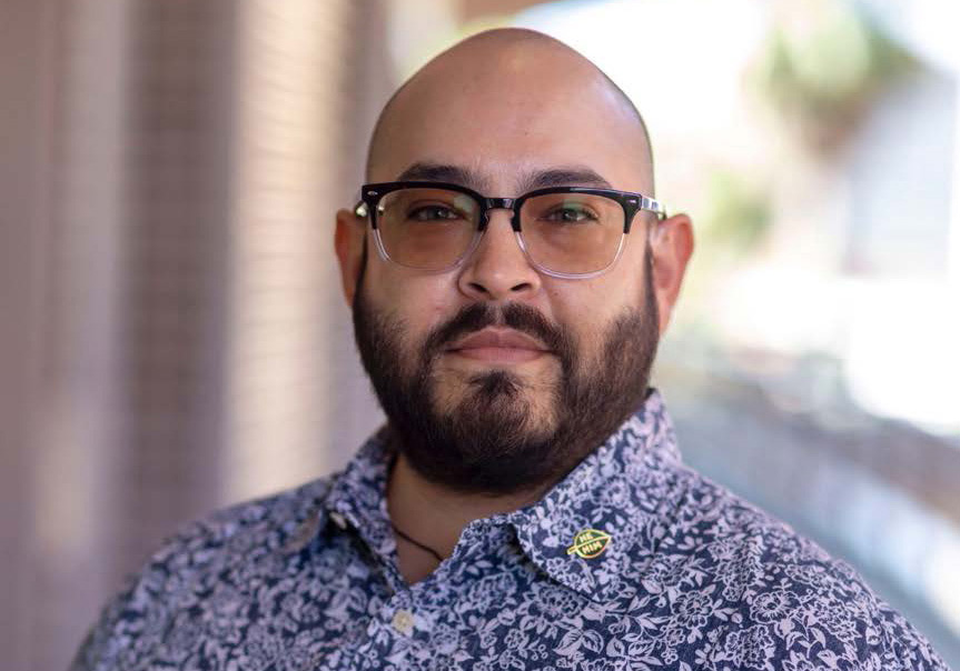 A person with a beard waring glasses.