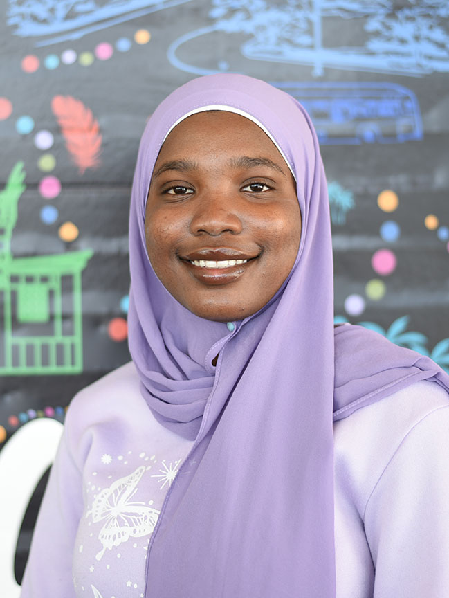 A person wearing a hijab smiling.