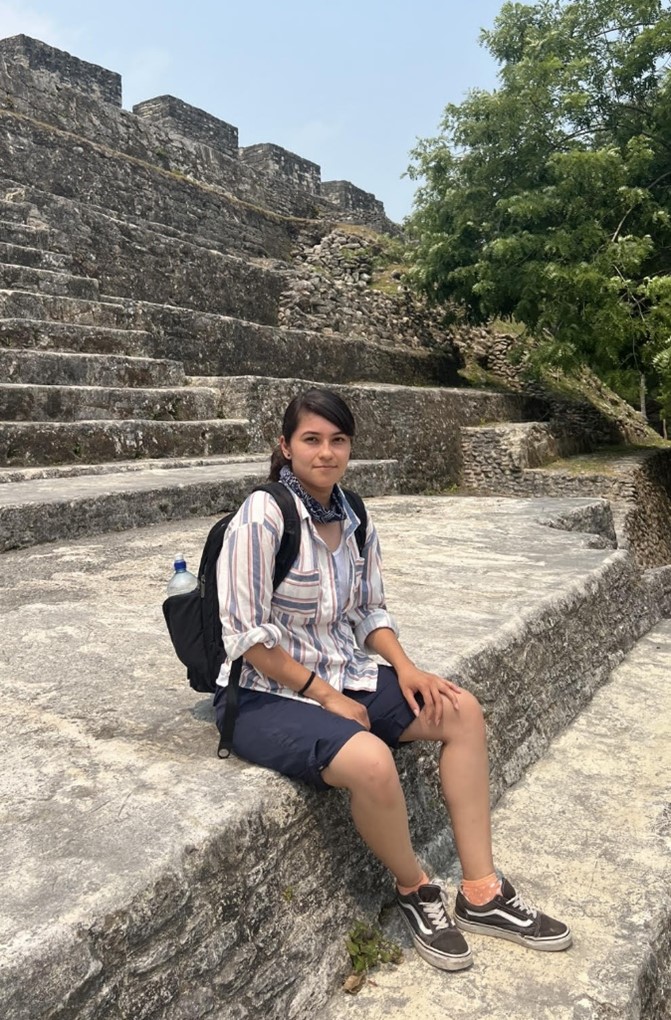 Grad Student sitting at the steps of an archaeological site