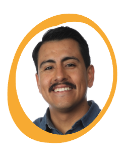 A smiling man with short dark hair and a mustache, wearing a blue collared shirt, shown in a head-and-shoulders portrait against a light background, framed by a yellow oval border