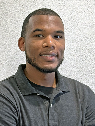 A person with short hair, a little facial hair, wearing a polo shirt.