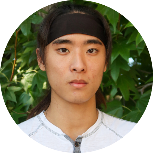 Man with black headband and white shirt looking at the camera.